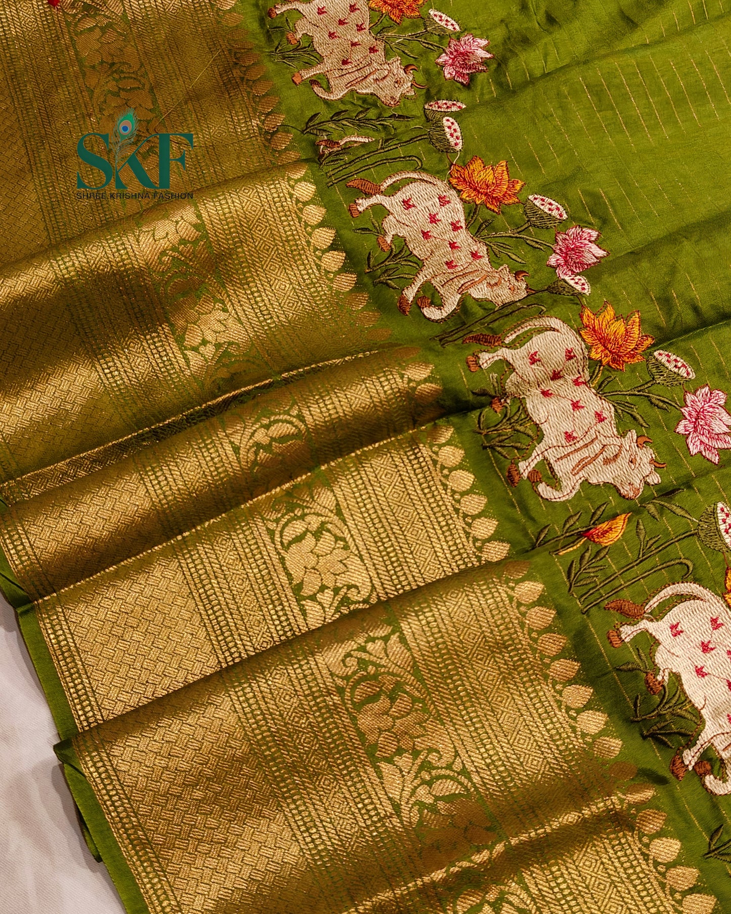 DOLA SILK MOTIF EMBROIDERY PANEL WEAVING BORDER WORK MEHNDI GREEN SAREE BY SKFBHOLUBHAI