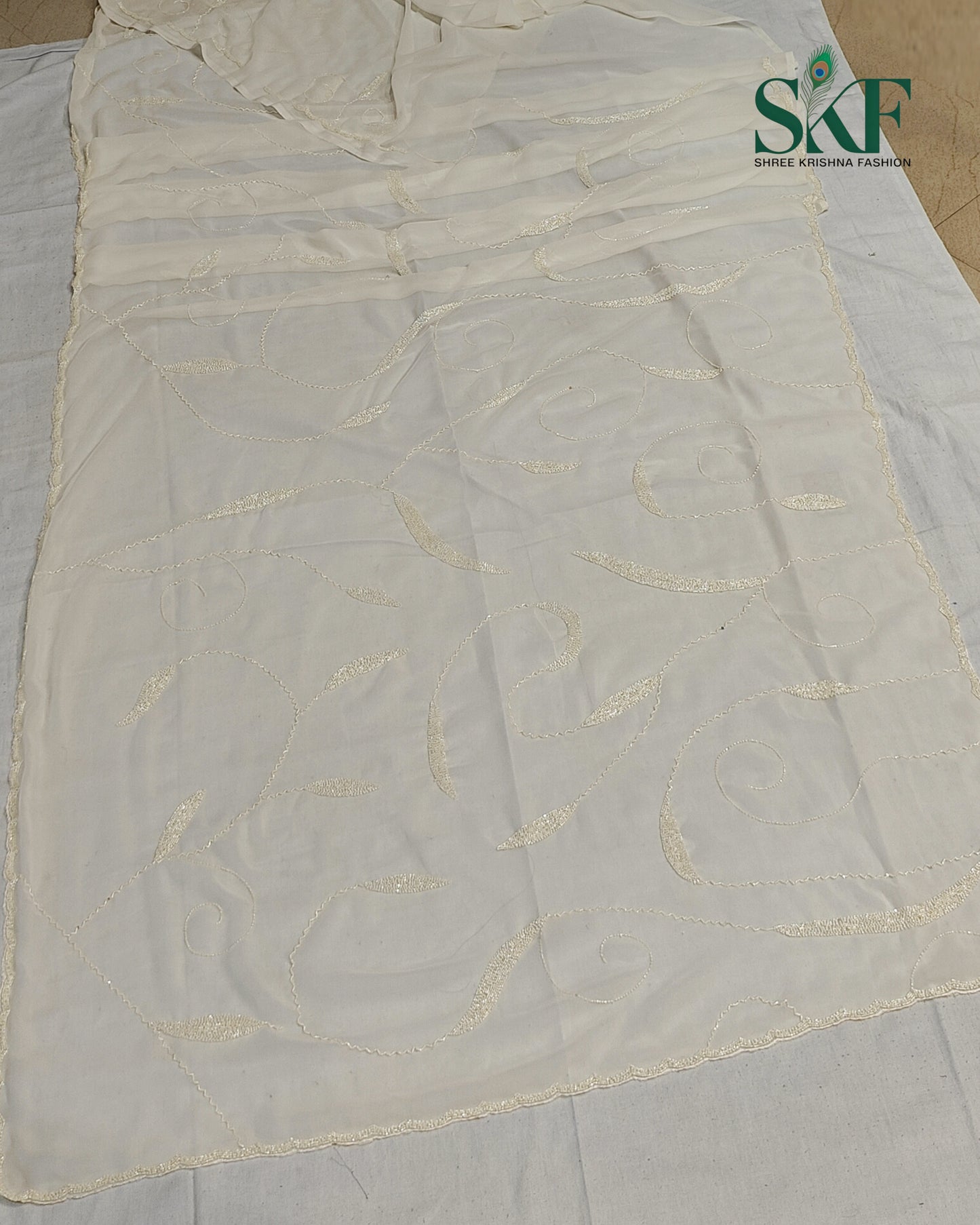 GEORGETTE IVORY KARDANA JAAL HANDWORK SAREE BY SKFBHOLUBHAI