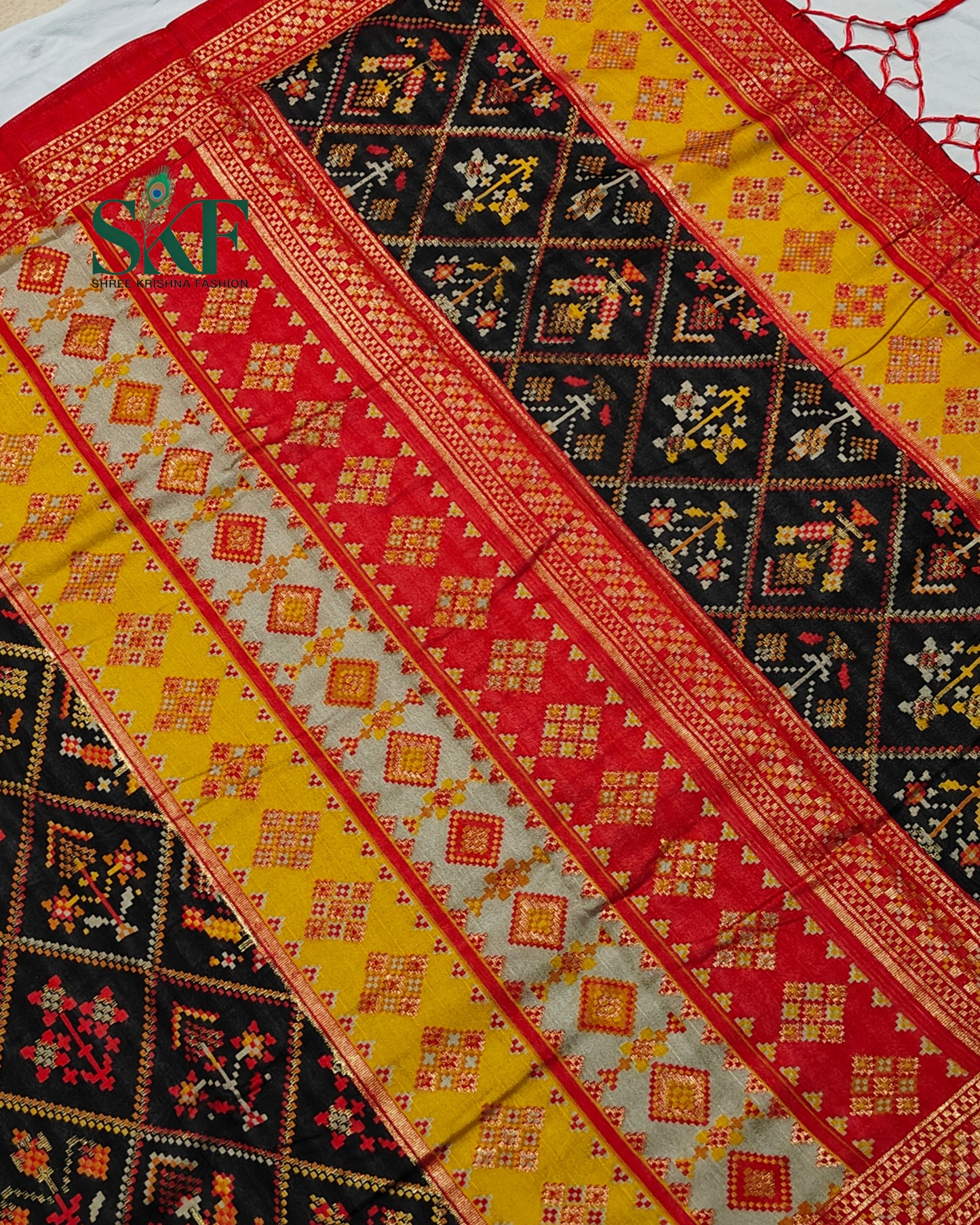 MAURA SILK PATOLA FOIL PRINT WEAVING BLACK SAREE BY SKFBHOLUBHAI