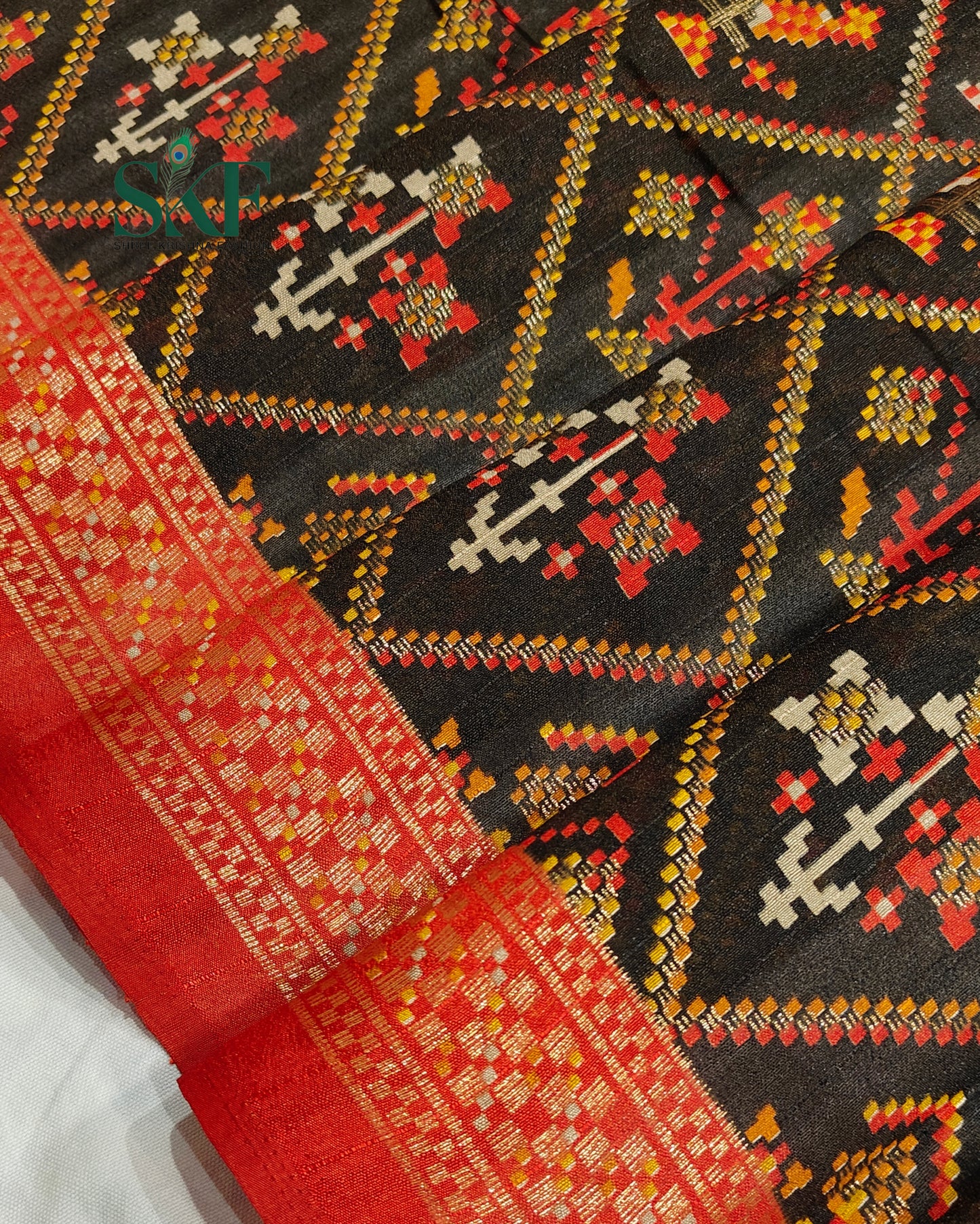 MAURA SILK PATOLA FOIL PRINT WEAVING BLACK SAREE BY SKFBHOLUBHAI
