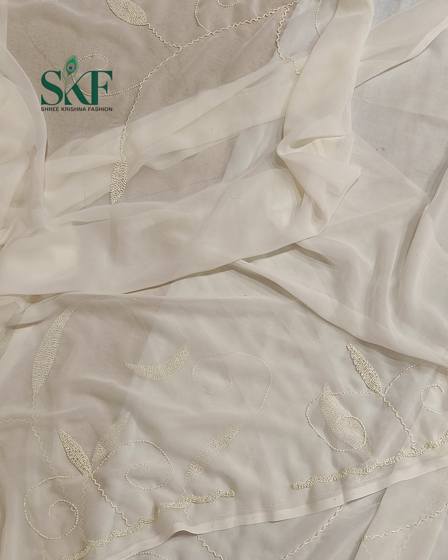 GEORGETTE IVORY KARDANA JAAL HANDWORK SAREE BY SKFBHOLUBHAI
