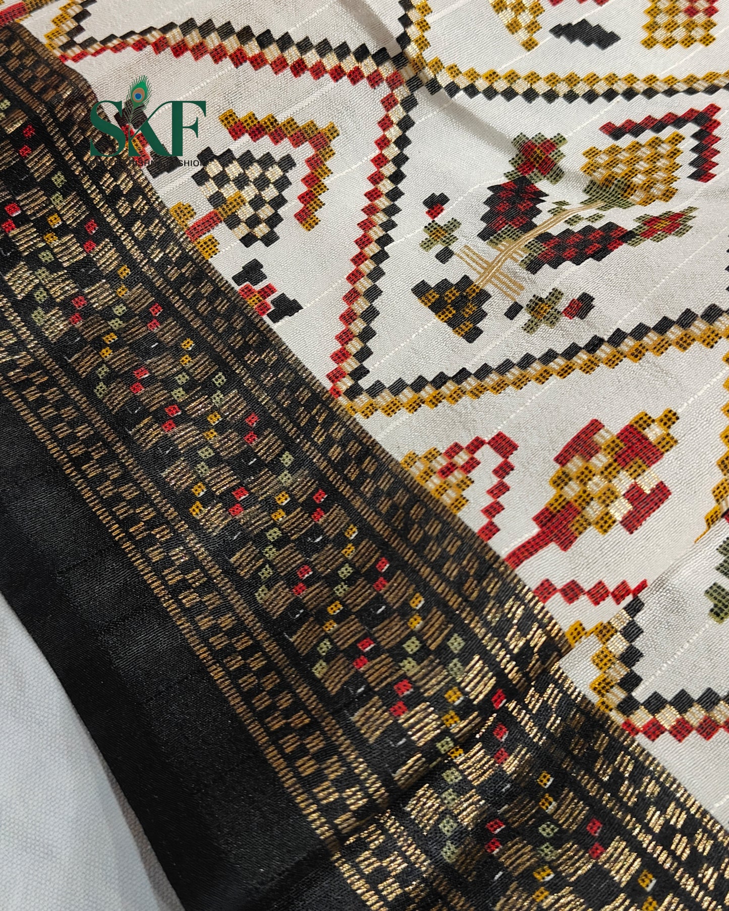 MAURA SILK PATOLA FOIL PRINT WEAVING IVORY SAREE BY SKFBHOLUBHAI