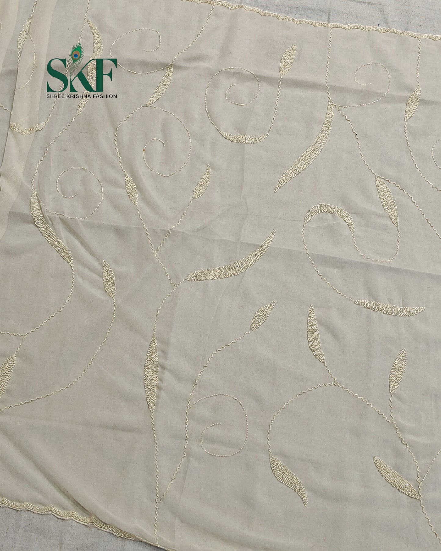 GEORGETTE IVORY KARDANA JAAL HANDWORK SAREE BY SKFBHOLUBHAI