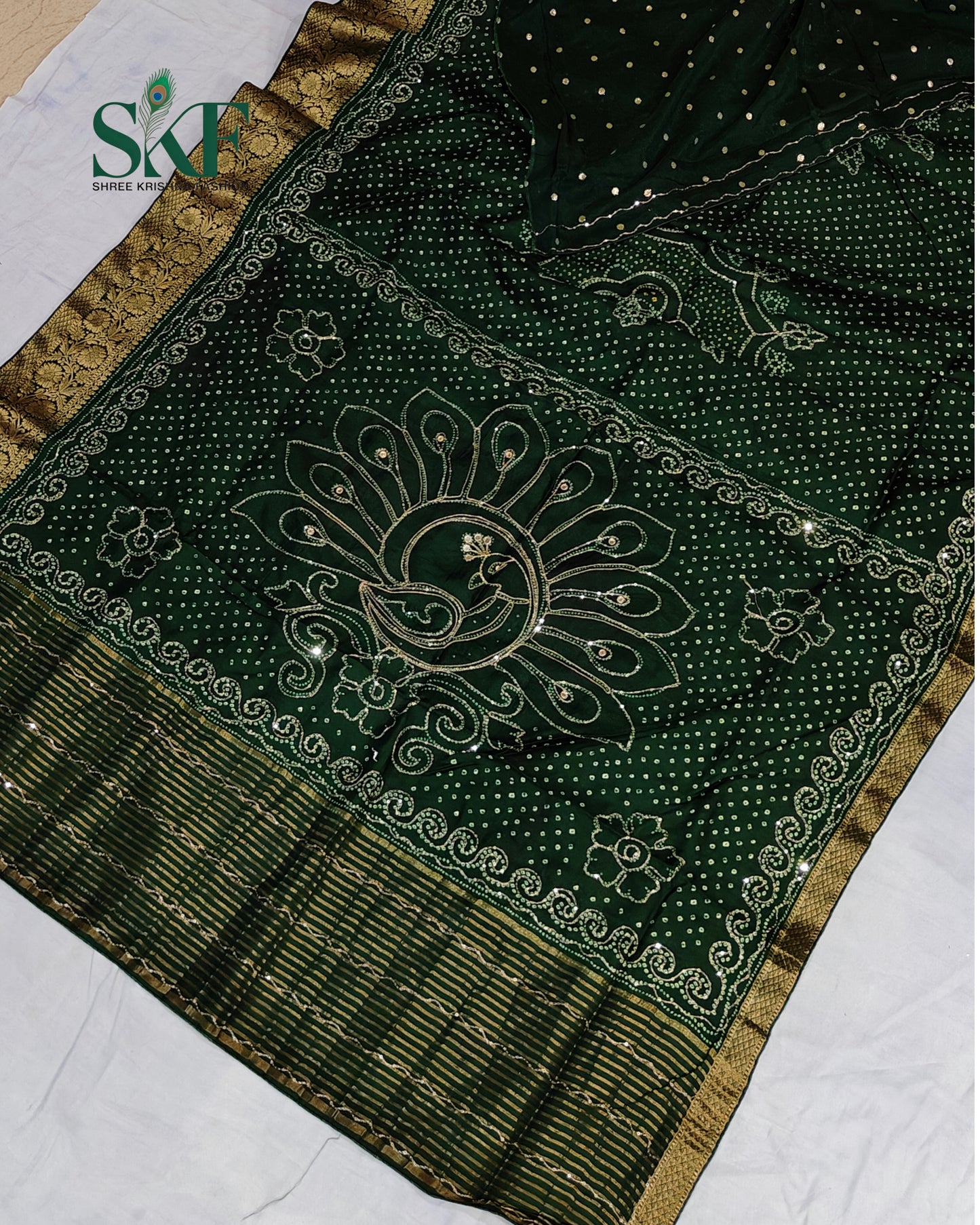 HO SILK BHANDHANI PEACOCK MOTIF AARI AND SEQUENCE WORK BOTTLE GREEN SAREE BY SKFBHOLUBHAI
