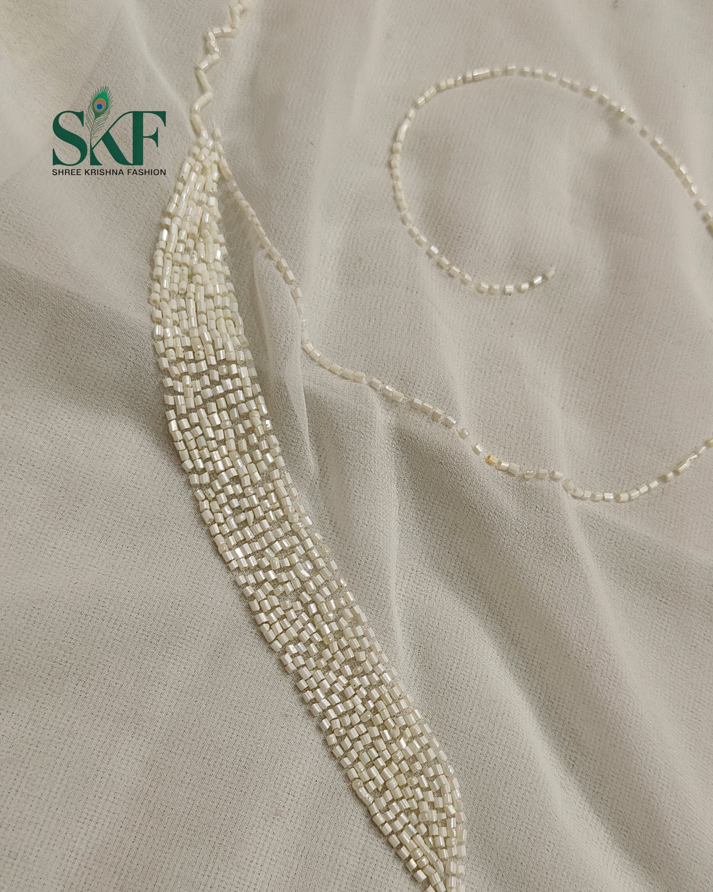 GEORGETTE IVORY KARDANA JAAL HANDWORK SAREE BY SKFBHOLUBHAI