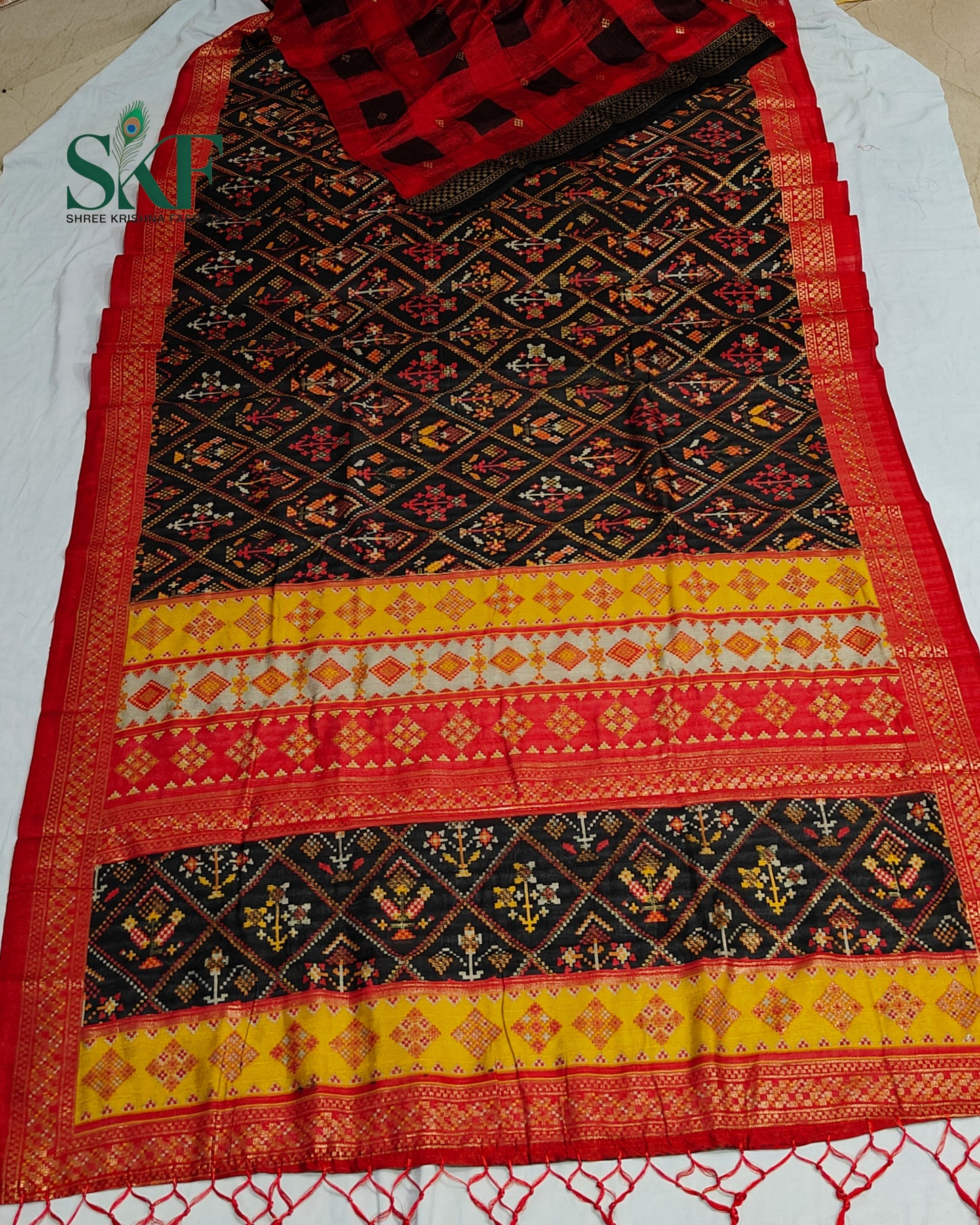 MAURA SILK PATOLA FOIL PRINT WEAVING BLACK SAREE BY SKFBHOLUBHAI