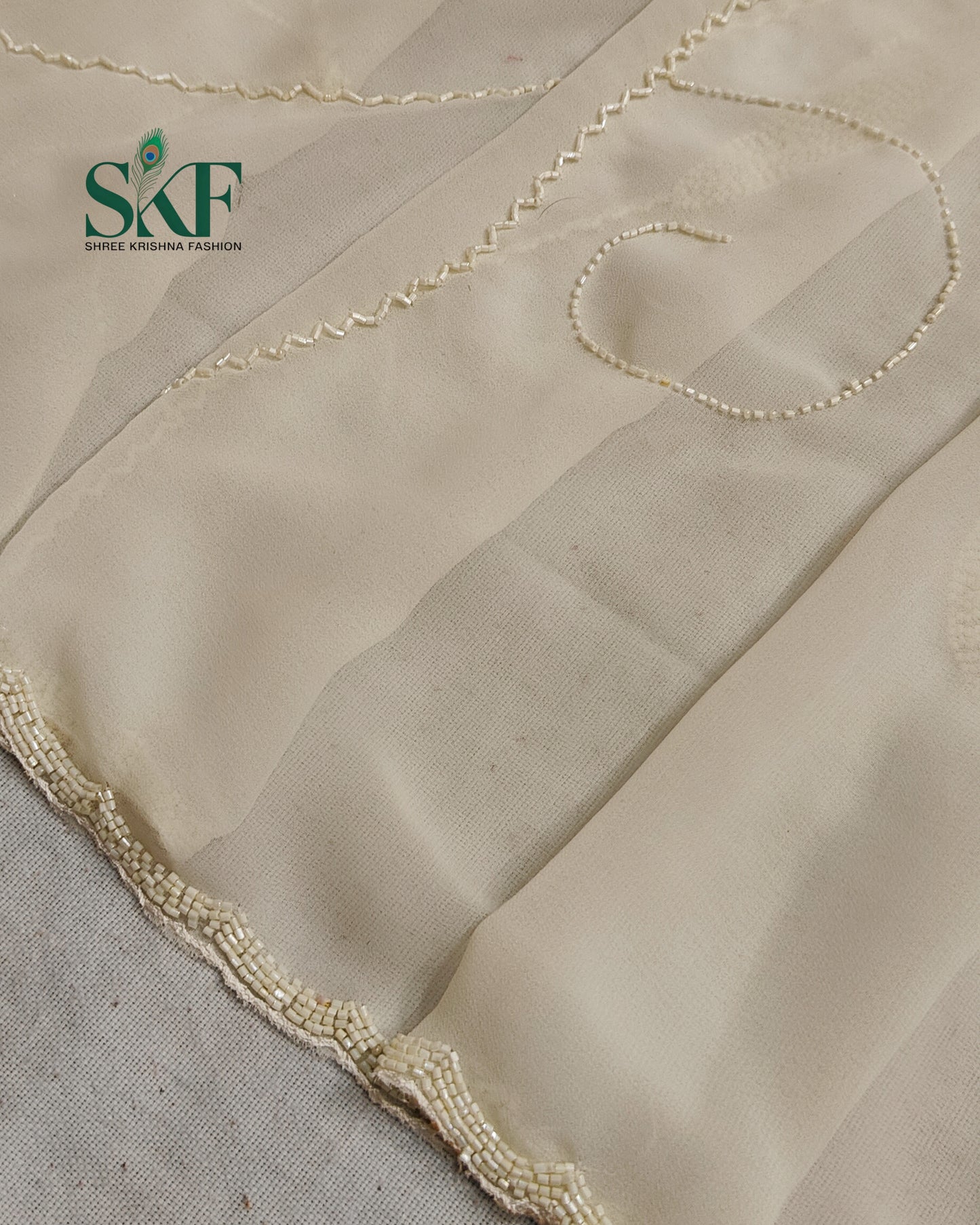 GEORGETTE IVORY KARDANA JAAL HANDWORK SAREE BY SKFBHOLUBHAI